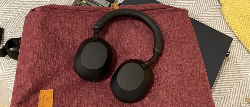 Sony WH-1000XM5 on a red background